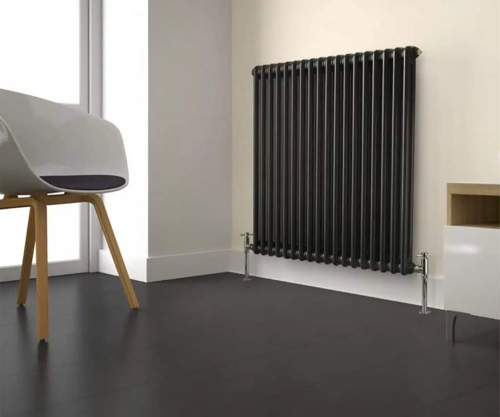 Modern black cast iron radiator in a contemporary home interior.