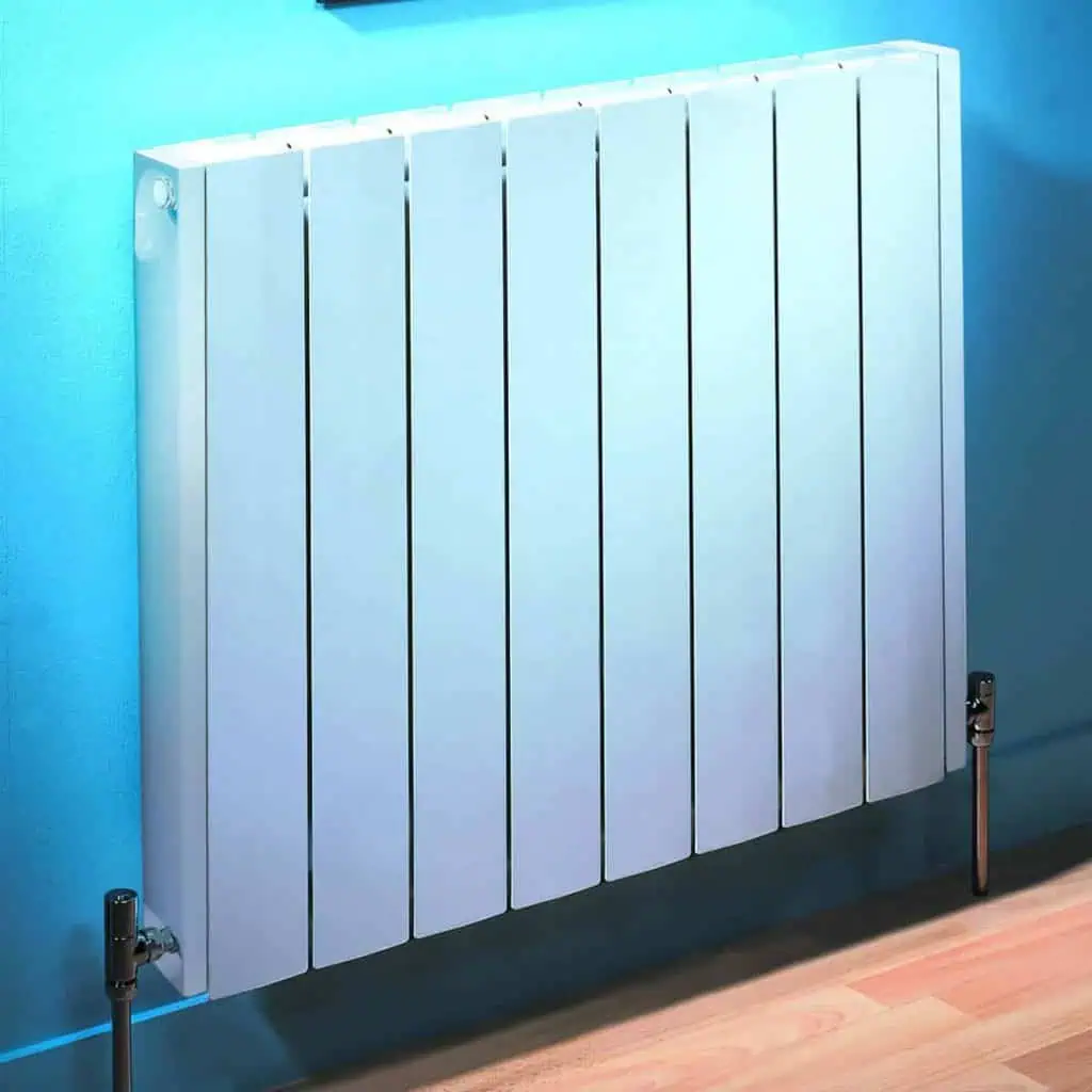 Clean modern white radiator, wall-mounted heating unit in contemporary home decor.