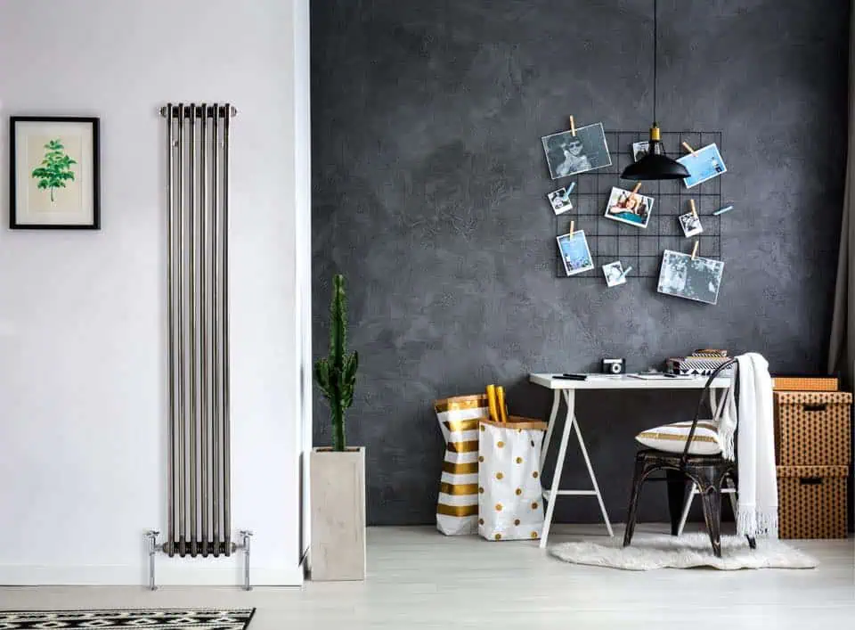 Modern home office with black and white decor and photo display wall.