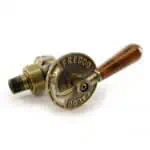 Vintage-style brass valve with wooden handle for plumbing or industrial use.