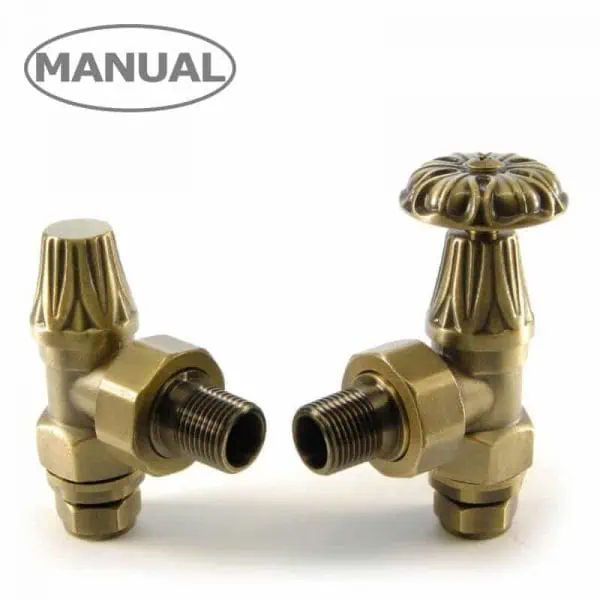 Brass radiator valves with decorative handles for heating system control.