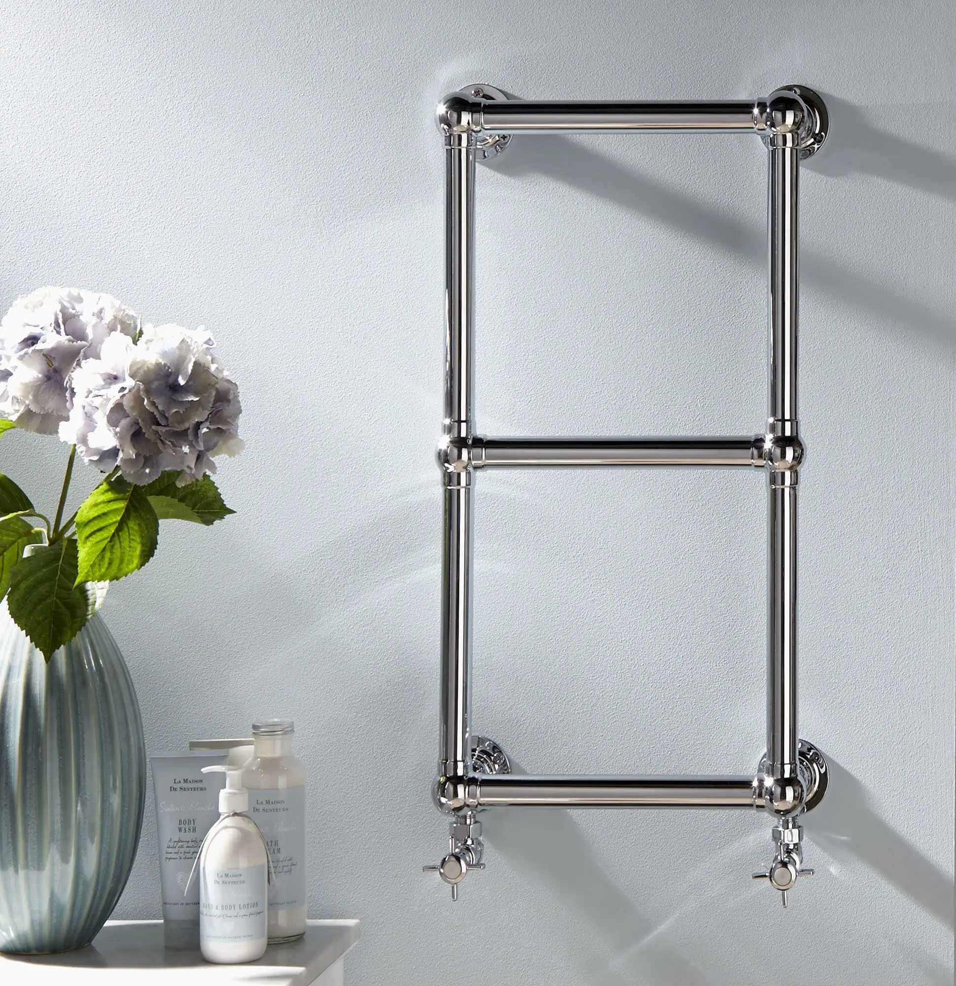 Aldworth-Lifestyle-1.jpg Polished chrome towel radiator in modern bathroom, wall mounted with valves.