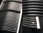 Polished stainless steel bathroom sink drain cover close-up image.