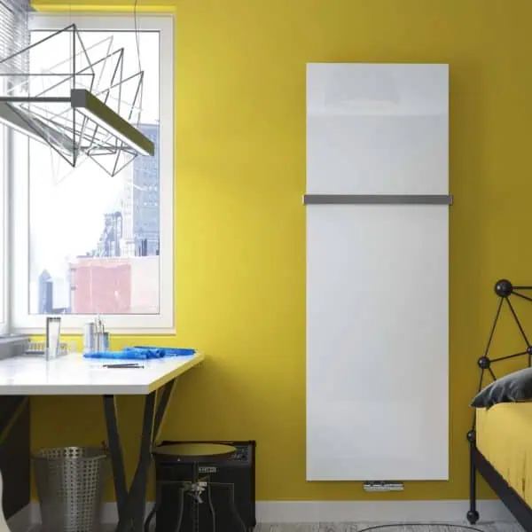 Modern radiator heating panel on a vibrant yellow wall in a contemporary bedroom or office space.