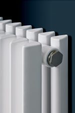 Radiator heating system for modern home or office, energy-efficient radiator with white finish.