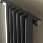 Radiator heating unit with modern black design for home and office warmth.