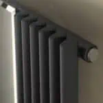 Radiator heating unit with modern black design for home and office warmth.