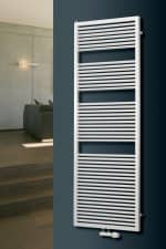 Radiator towel warmer in modern bathroom, white heated towel rail for home comfort and heat efficiency.
