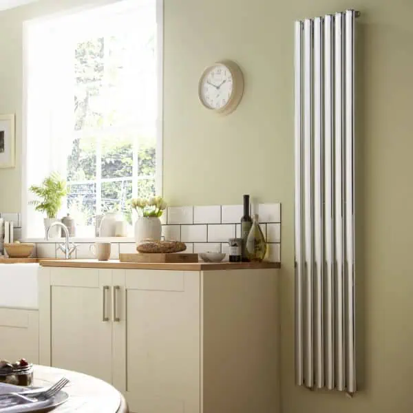 Radiator heating system in modern kitchen, energy-efficient wall mounted radiator design, home heating solution, wall-mounted chrome radiator, eco-friendly heating appliance.