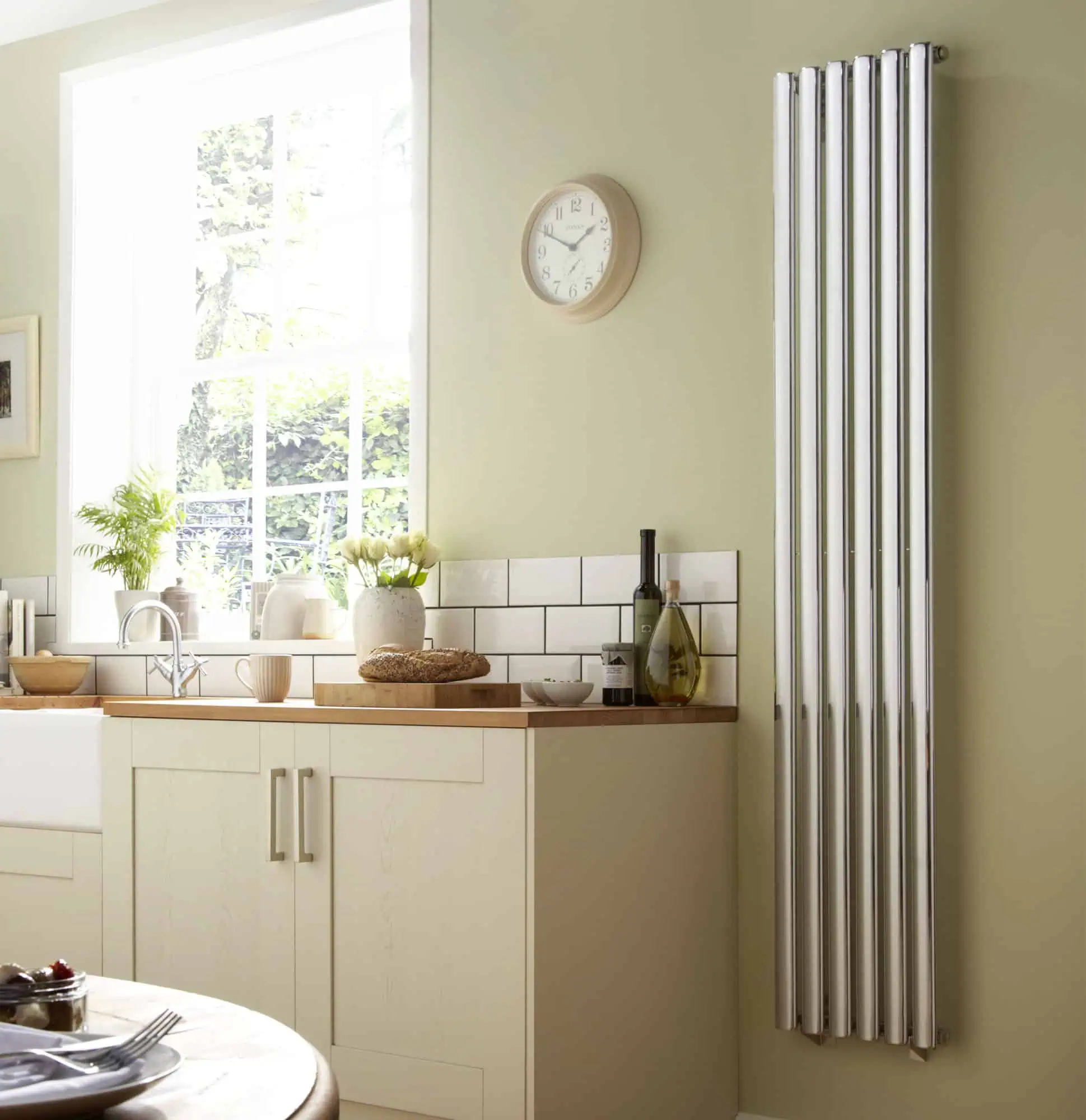 Dorney-Vertical-Lifestyle-1.jpg Radiator heating system in modern kitchen, energy-efficient wall mounted radiator design, home heating solution, wall-mounted chrome radiator, eco-friendly heating appliance.