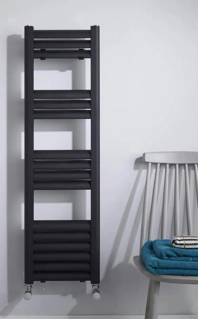 Eton-Anthracite-1.jpg Black modern radiator towel warmer on a white wall in a bathroom setting.