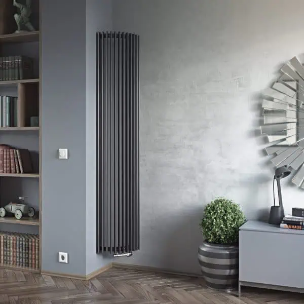 Vertical modern black radiator in a contemporary living room setting.