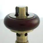 Vintage chess piece with brass and wood finish, detailed craftsmanship, and classic design.