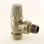 Brass radiator valve with threaded and control knob for heating system installation.