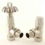 Shiny metallic radiator valves with thermostatic control for heating system.