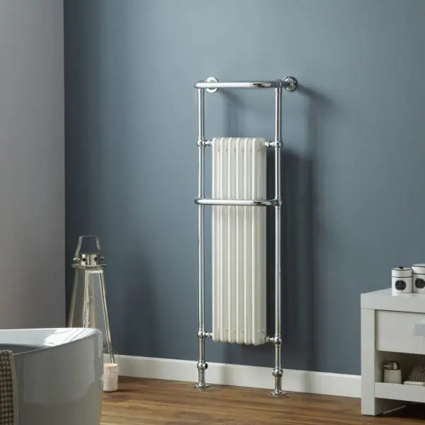 Shower radiator with chrome finish in modern bathroom setting.