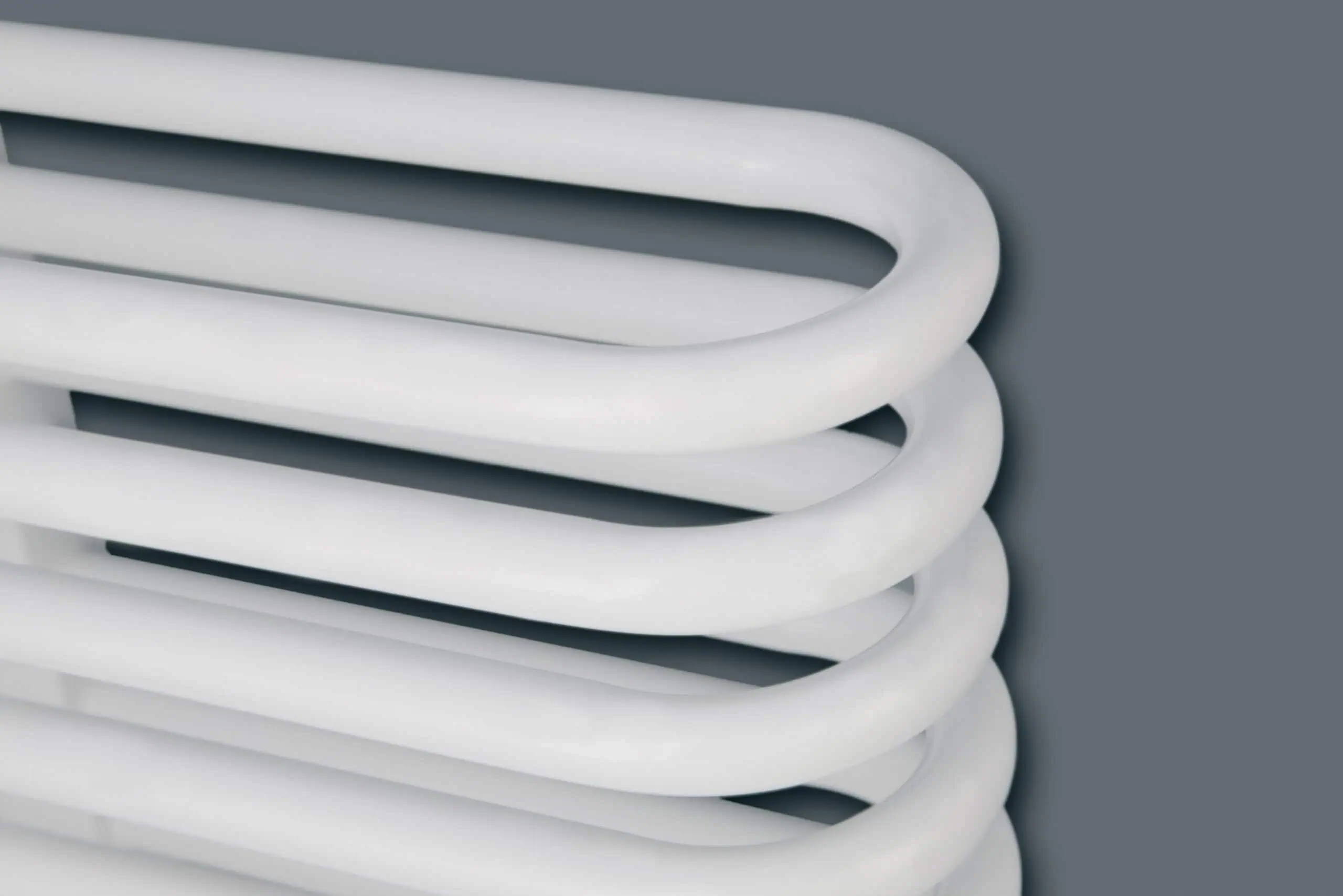 Helios-Detail-scaled-2.jpg White modern towel radiator heating element for homes and bathrooms.