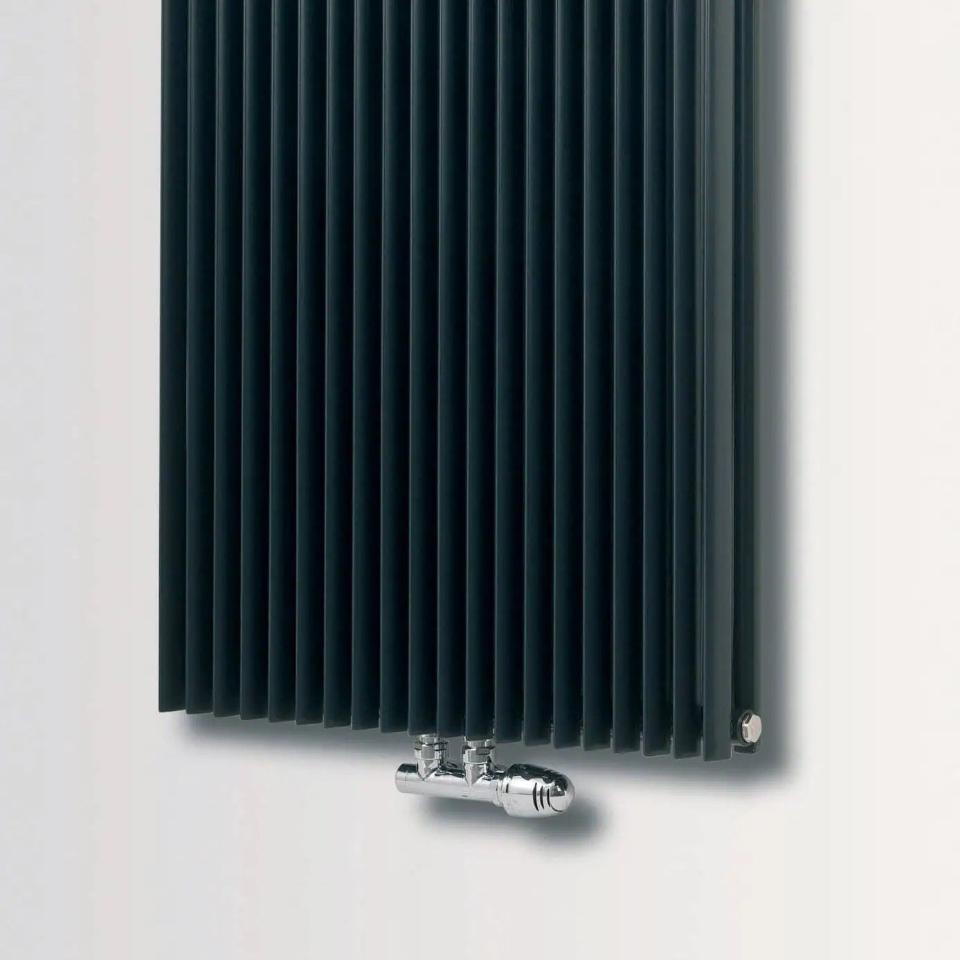 Hertz-Deluxe-Chrome-Valve-1.jpg Black radiator with vertical fins, modern design for heating solutions.