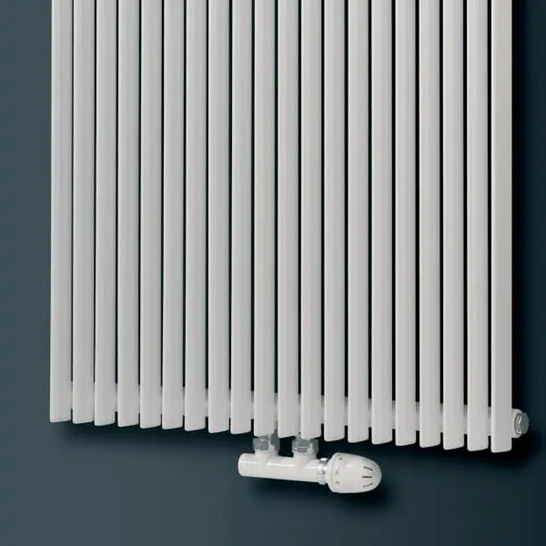 Modern white radiator with adjustable thermostat for home heating.