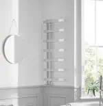 Radiator towel warmer in modern bathroom, sleek stainless steel finish, wall-mounted heating solution.