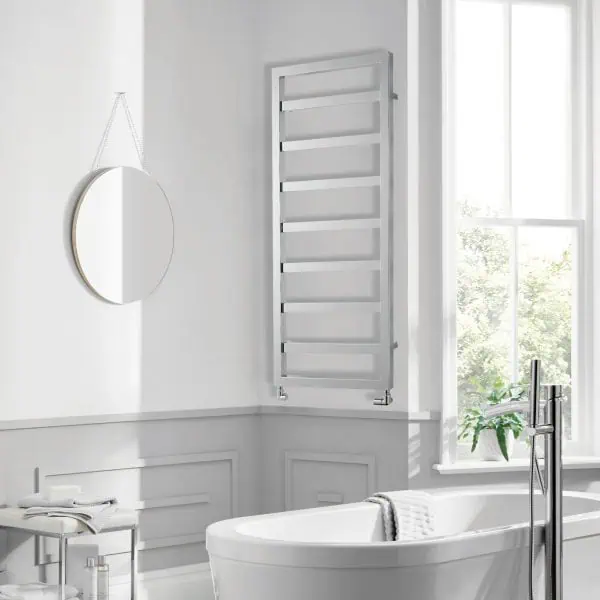 Modern white heated towel rail in a bright bathroom setting.