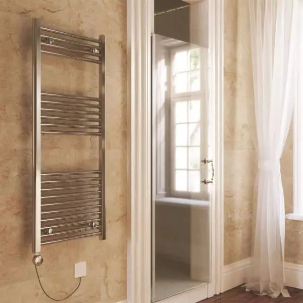 Stainless steel towel radiator installation in a modern bathroom.