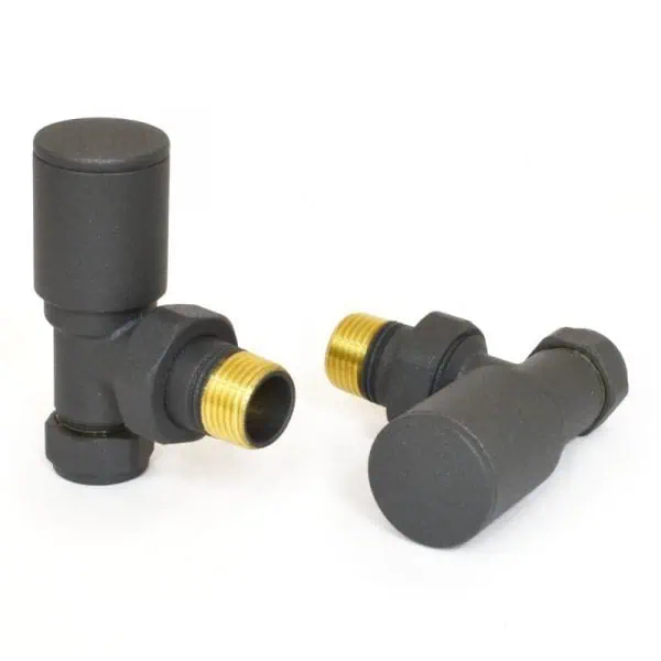 Black plastic radiator valves with brass threaded fittings for central heating systems.