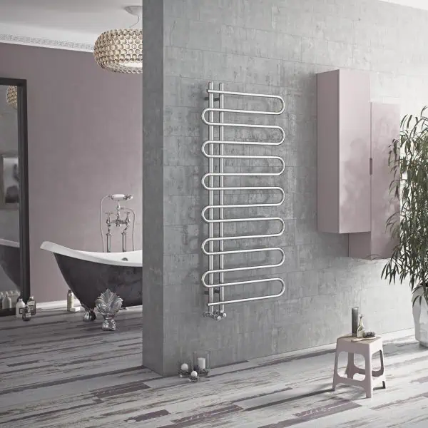 Modern heated towel radiator in stylish bathroom, wall-mounted design, chrome finish.