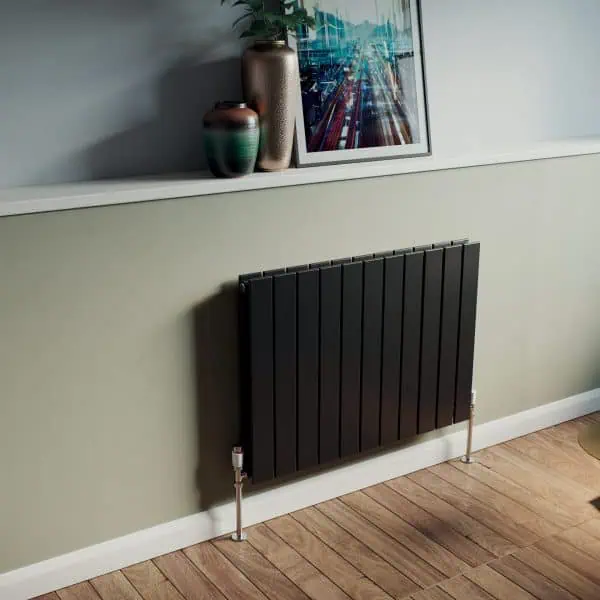 Modern black wall radiator in a stylish living room setting.