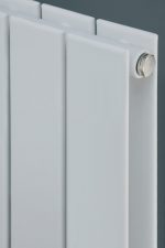 Radiator heating system close-up, modern white panel radiator, energy-efficient heating solution for homes and offices.