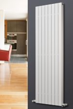 Radiator heating panel in modern home interior, vertical white vertical radiator on gray wall.