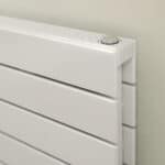 Clean white radiator with modern heating controls in a contemporary home.