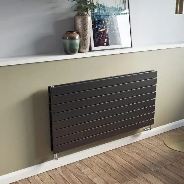 Modern black radiator on a wall in stylish interior setting.