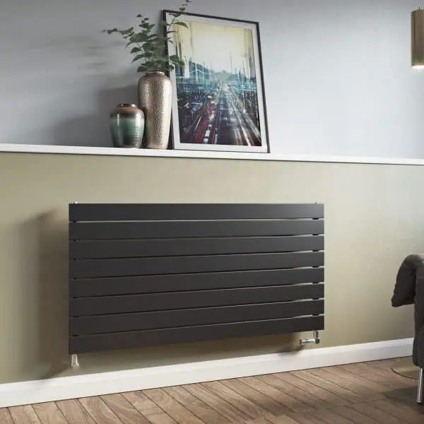 Modern black radiator heating panel in contemporary living room setting.