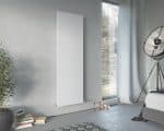 Modern vertical white panel radiator in a contemporary bedroom setting.