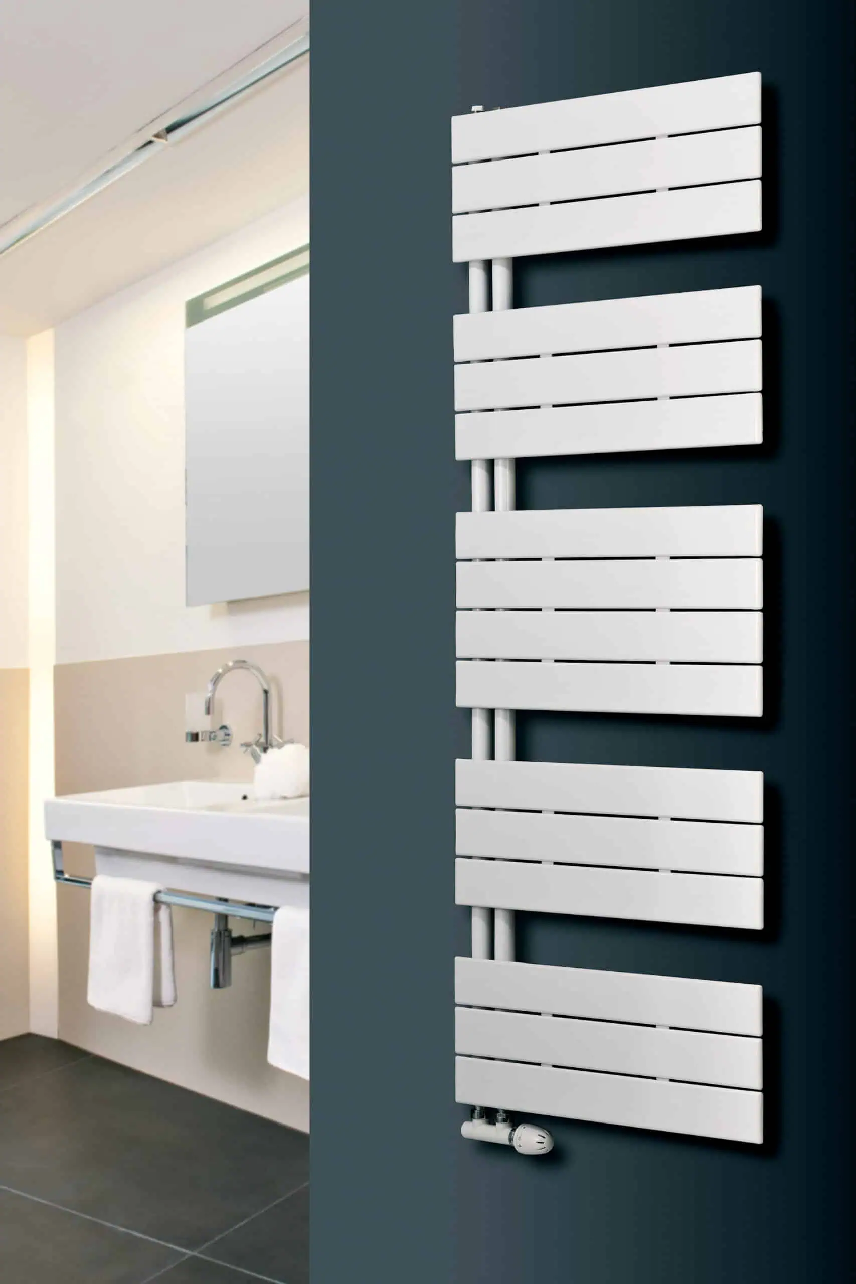 Mars-Trium-scaled-2.jpg Modern white radiator installed in a contemporary bathroom for efficient heating and stylish decor.