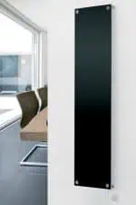 Polycarbonate electric radiator panel in modern office interior, sleek black design.