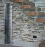 Polished chrome towel radiator in modern interior home decor.
