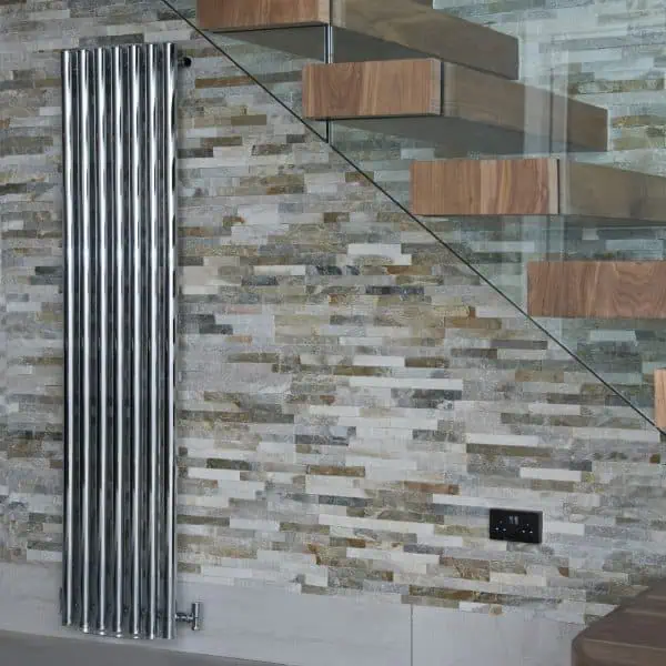 Polished chrome towel radiator in modern interior home decor.