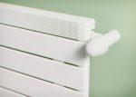 White electric radiator with modern design for home heating.