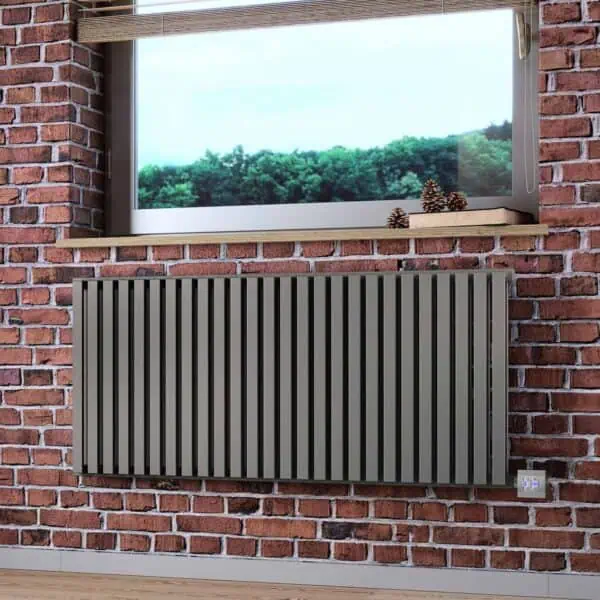 Modern radiator with vertical slats mounted on a red brick wall in a contemporary interior.