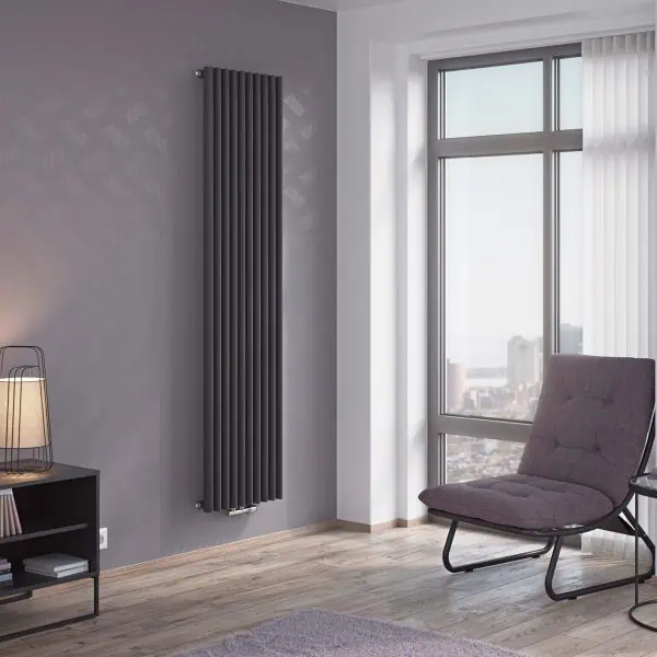 Modern vertical black radiator in stylish living room corner with large window and armchair.