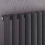 Modern black radiator with sleek design in contemporary interior.