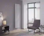 Modern vertical radiator in a stylish living room with large windows and contemporary decor.