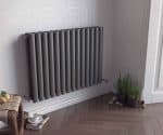 Stylish modern gray radiator in a contemporary living space, eco-friendly heating solution.