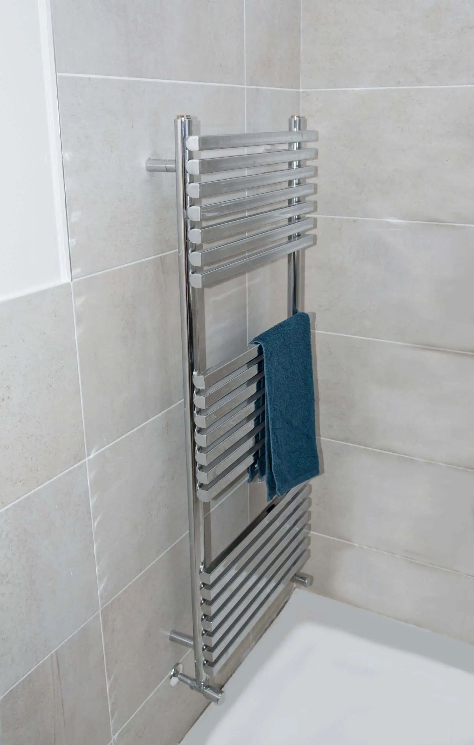 Oxfordshire-TR-Lifestyle-scaled-2.jpg Polished chrome towel radiator in modern bathroom wall.