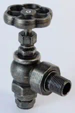 Vintage industrial water valve with threaded pipe fitting for plumbing systems.