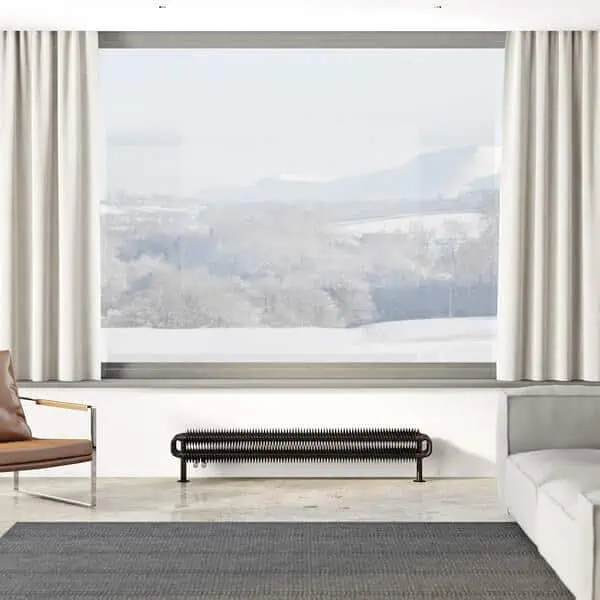 Bright living room with large window overlooking scenic landscape, modern sofa and stylish decor.