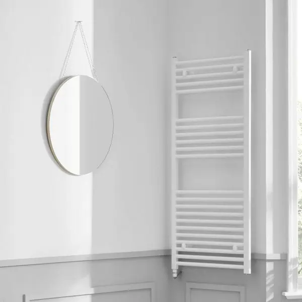 Round mirror with a sleek frame hanging on a wall in a modern bathroom.