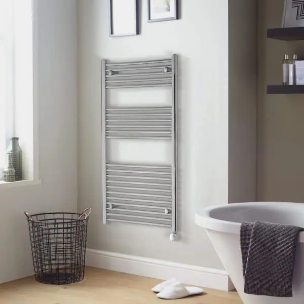 Radiator towel rail in modern bathroom with white walls and wooden flooring.